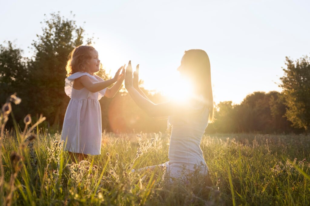 A woman with a child with sunshine showing the the child is happy and at the same time the Women's inner child is healing.
