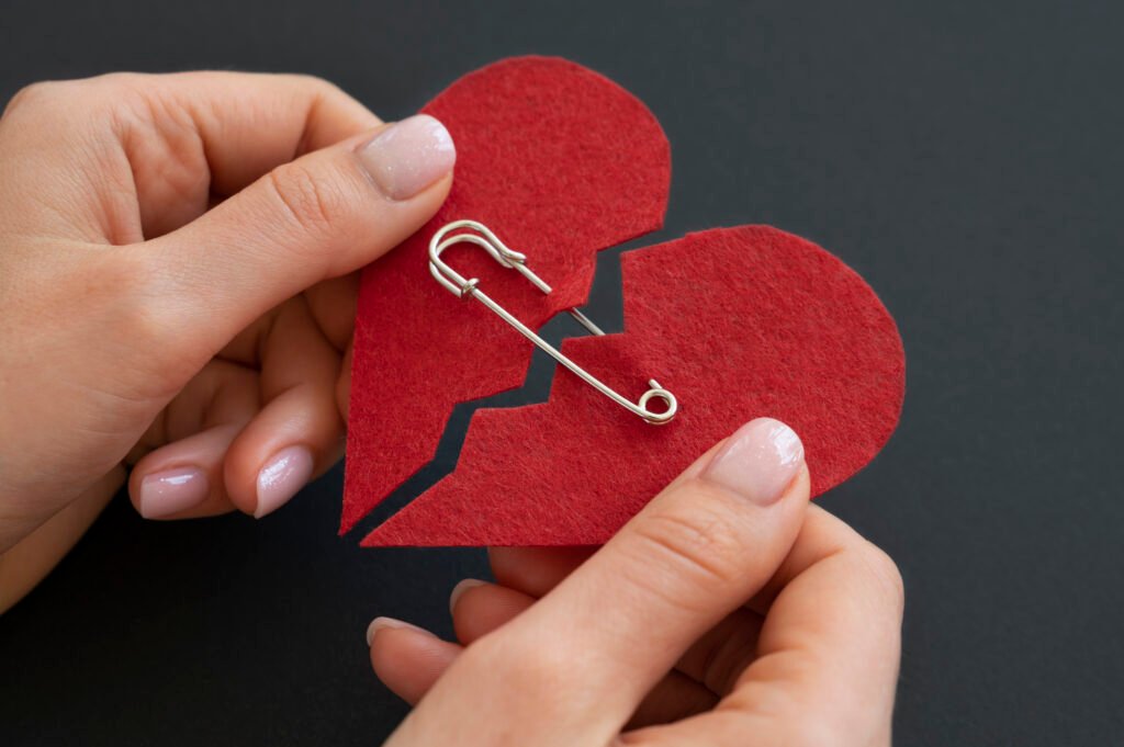 An image with two hearts holded by pin depicting attachment styles.