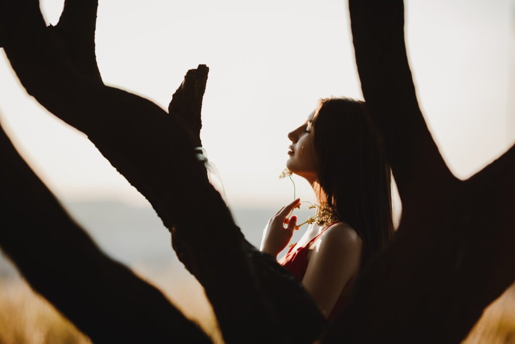 A woman standing alone and observing her thought is depicting shadow work